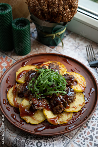 Chicken liver with apples, cherry sauce and arugula