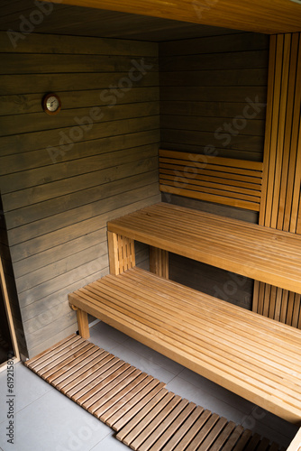 Fototapeta Naklejka Na Ścianę i Meble -  Interior of Finnish sauna, classic wooden sauna with hot steam. Wooden interior baths, wooden benches and loungers, spa complex.