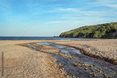 Stream leading down to Freshwater East beach in evening