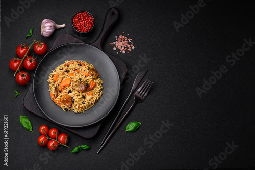 Delicious fresh pilaf with rice, carrots, meat, onions, spices and berries