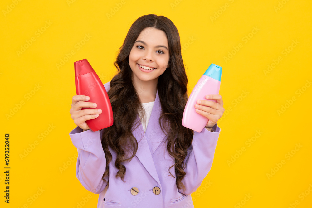 Child with shampoo conditioner. Daily cosmetic care. Teenager kid 12, 13, 14 years old hold bottle of hair and skin care. Beauty health and cosmetics. Happy teenager. Child with shampoo conditioner. Daily cosmetic care. Teenager kid 12, 13, 14 years old hold bottle of hair and skin care. Beauty health and cosmetics. Happy teenager.