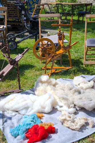 Spinning wheel and equipment on the open air. Yarn, wool, thread.