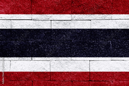 Flag of the Kingdom of Thailand on a textured background. Concept collage.