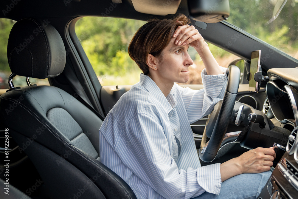 Stressed middle aged woman driving car having problems on road looking ahead. Nervous female feeling fear, fright, aggression standing in traffic jam on rush hour. Exhausted frustrated shocked driver. Stressed middle aged woman driving car having problems on road looking ahead. Nervous female feeling fear, fright, aggression standing in traffic jam on rush hour. Exhausted frustrated shocked driver.
