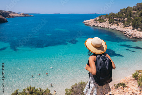 Anonymous young woman admiring amazing view of blue sea on Balearic Islands photo