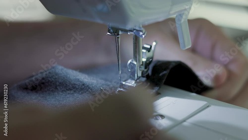 tailor finishing the hem on the pants leg