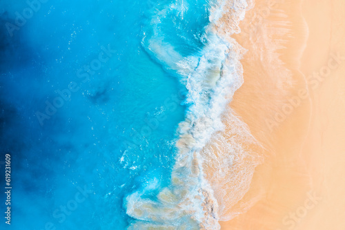 Coast as a background from top view. Waves and beach. Aerial landscape. Azure water background from drone. Summer seascape from air. Vacation time.