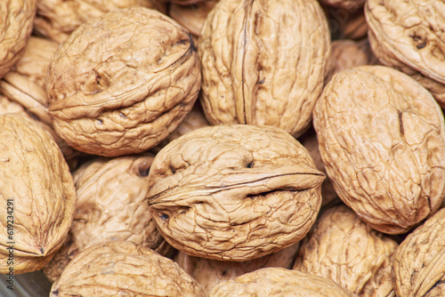Stacked unpeeled solid walnuts pattern texture background