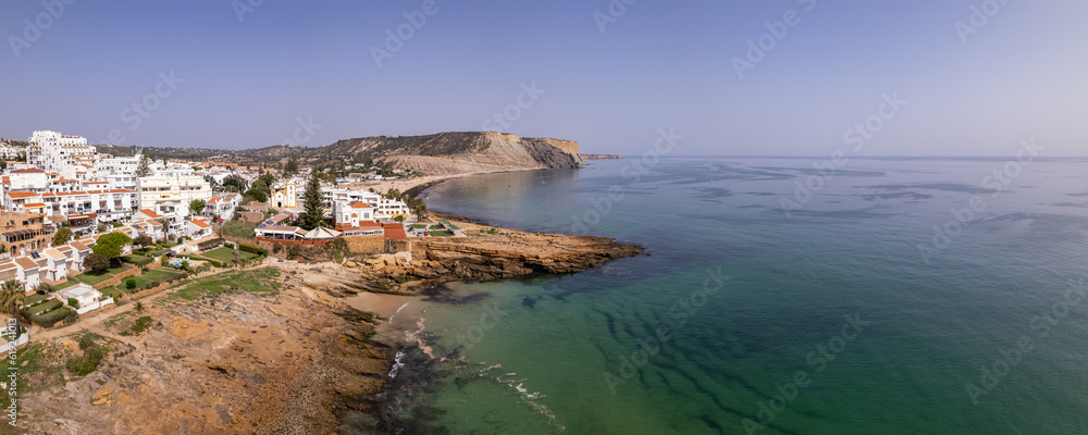 Aerial seascape, of Praia da luz (Beach and seaside cliff formations along coastline of Lagos city), famous destination in Algarve. South Portugal.