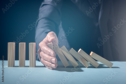Obraz na plátně businessman hand stopping falling collapse wooden block domino