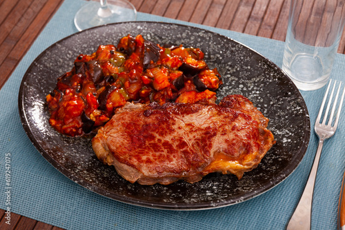 Veal steak baked in oven served with assorted braised vegetables