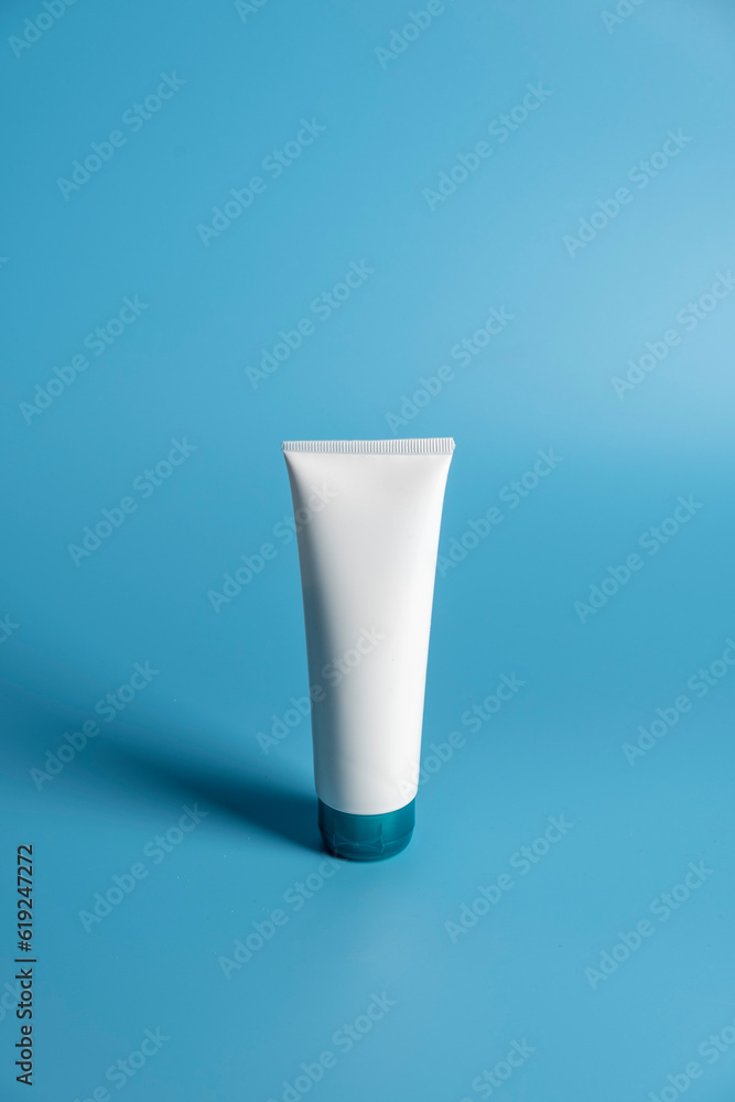 Plastic tube with sunscreen cream on blue background. Plastic tube with sunscreen cream on blue background.