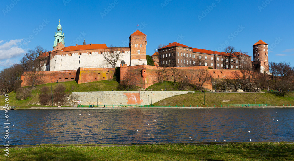 Medieval fortified architectural complex of Wawel Сastle and bell tower of Archcathedral Basilica on banks of Vistula river in springtime, Krakow, Poland..