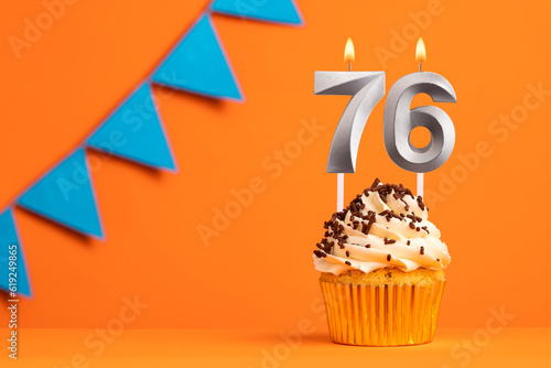 Candle number 76 - Cake birthday in orange background