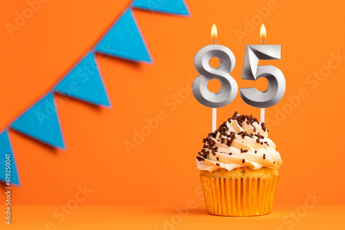 Birthday cake with candle number 85 - Orange background