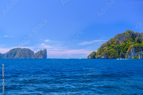 Speed boats in the bay of Ko Phi Phi Don Island with huge rocks and cliffs on a sunny day, Ao Nang, Mueang Krabi District, Krabi, Andaman Sea, Thailand