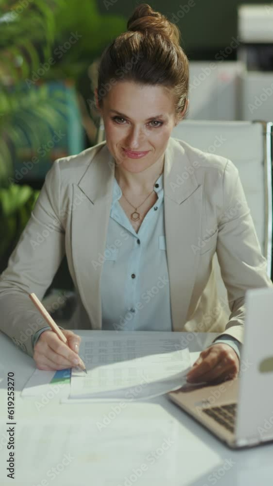pensive modern female employee in a light business suit in modern green ...