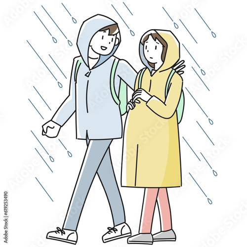 雨の中を避難する妊婦と支援する男性