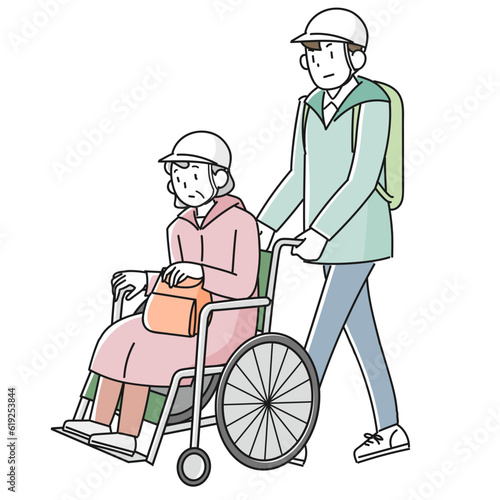 災害時に避難する車椅子に乗った高齢女性と支援する男性