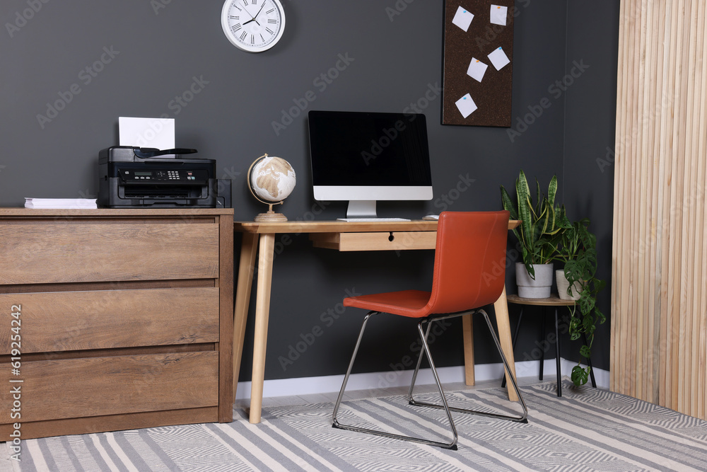 Stylish workplace with modern computer and printer at home Stylish workplace with modern computer and printer at home