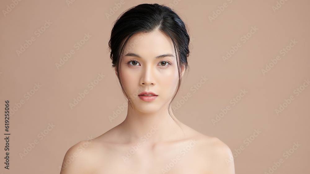 Fototapeta premium Beautiful young asian woman with clean fresh skin on beige background, Face care, Facial treatment, Cosmetology, beauty and spa, Asian women portrait.