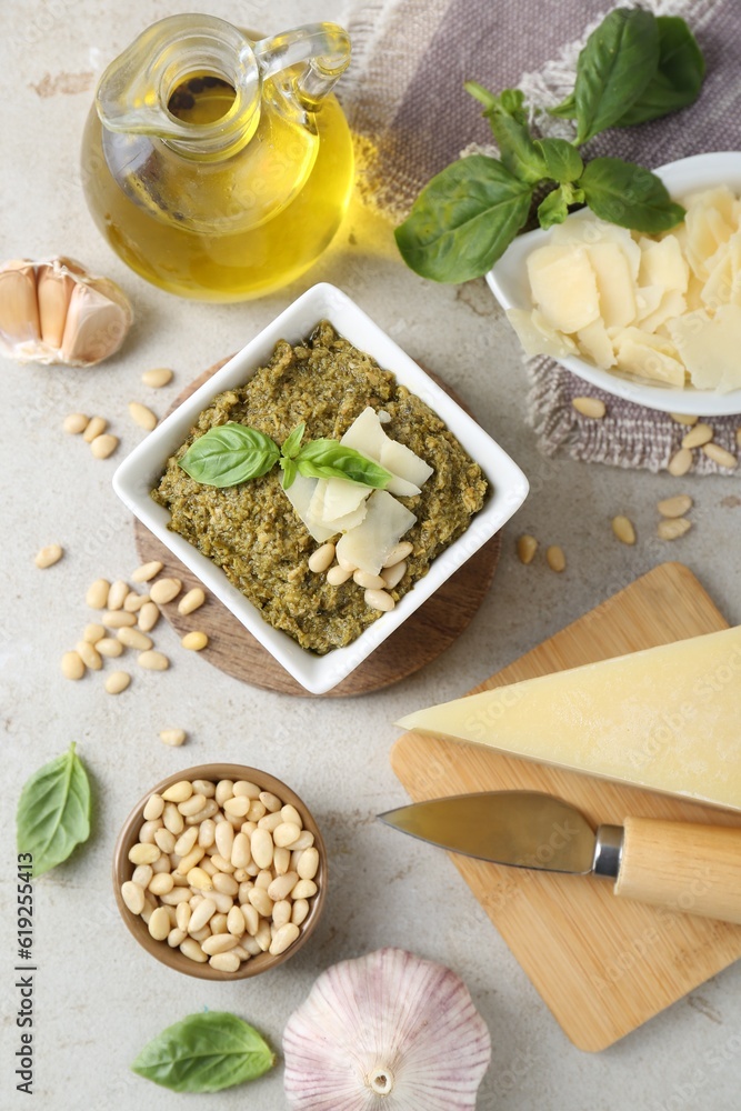 Delicious pesto sauce and ingredients on light table, flat lay Delicious pesto sauce and ingredients on light table, flat lay