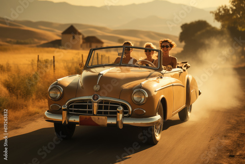 Nostalgic Road Adventures: Young Women Friends Raising Hands in a Classic Convertible Car on a Picturesque Country Road  © Mr. Bolota