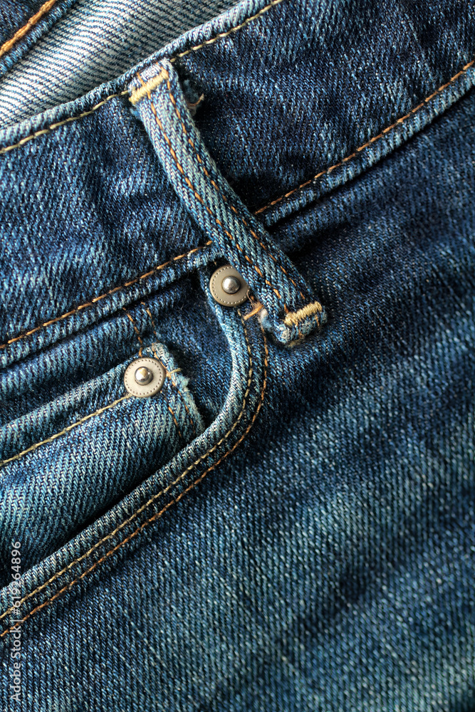 Detail of a front pocket of a blue denim Detail of a front pocket of a blue denim