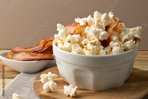 Salty popcorn with bacon on table.