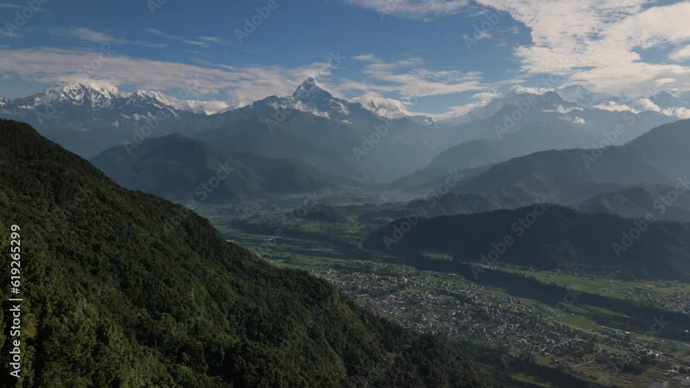 Drone flight overlooking the great Himalayas in Nepal on a sunny day. Aerial view of the Nepalese city of Pokhara and snowy high mountains. 4k footage. Drone flight overlooking the great Himalayas in Nepal on a sunny day. Aerial view of the Nepalese city of Pokhara and snowy high mountains. 4k footage.