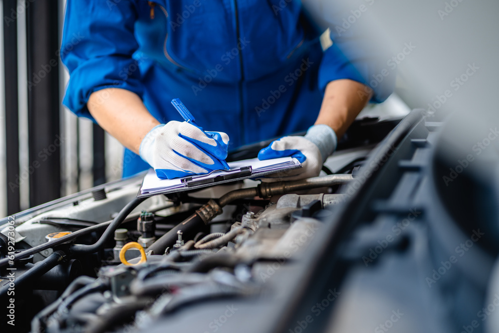 Automotive mechanic repairmen checking the system working engine of the engine room, check the mileage of the car, oil change, auto maintenance service concept. Automotive mechanic repairmen checking the system working engine of the engine room, check the mileage of the car, oil change, auto maintenance service concept.