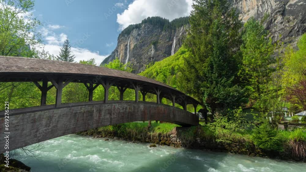 Lauterbrunnen Switzerland Timelapse. Pedestrian Bridge, River, Green Landscape and Waterfalls in Swiss Alps Lauterbrunnen Switzerland Timelapse. Pedestrian Bridge, River, Green Landscape and Waterfalls in Swiss Alps