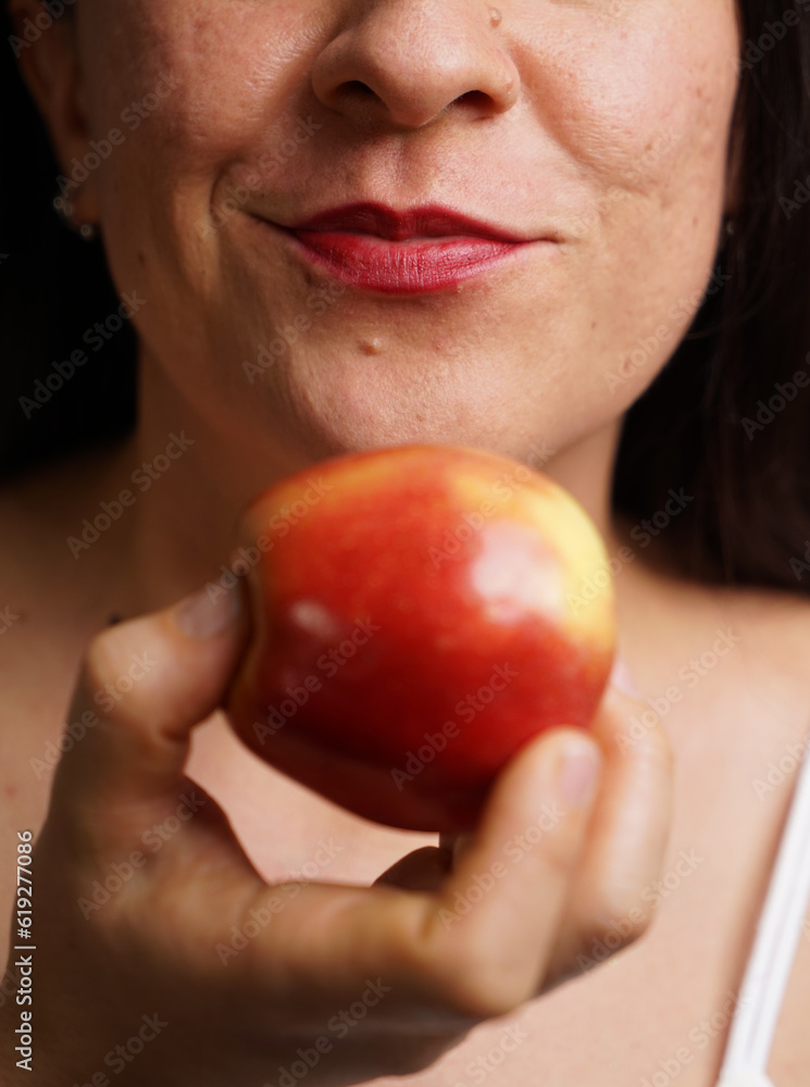 closeup of woman holding an apple, apple concept closeup of woman holding an apple, apple concept