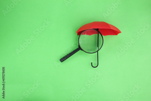 magnifying lenses and umbrellas. The concept of seeking insurance protection or coverage. Family protection concept 