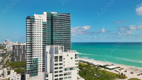 Miami Beach city with high luxury hotels and condos and sandy beachfront. High angle view of tourist infrastructure in southern Florida, USA