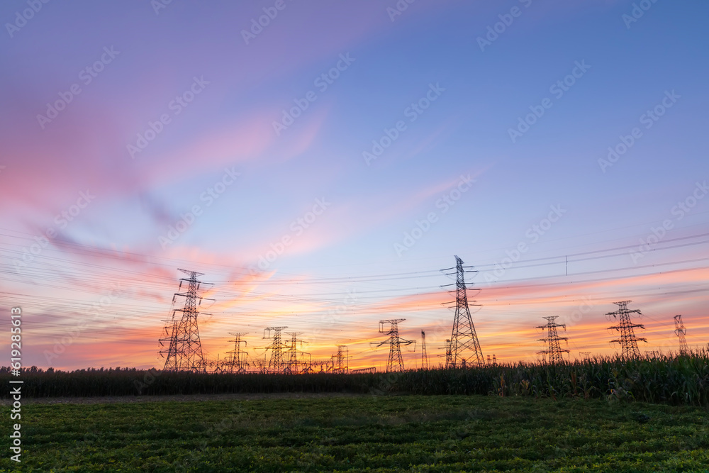 Fototapeta premium In the evening, the silhouette of high voltage towers