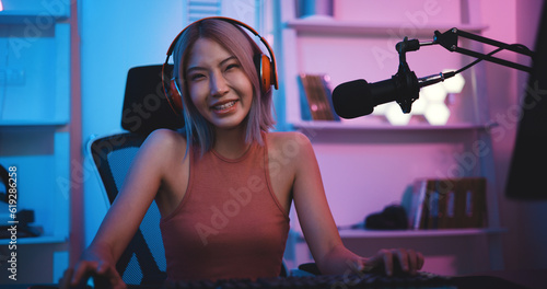 Asian young Esport woman gamer enjoy to play online game on PC
