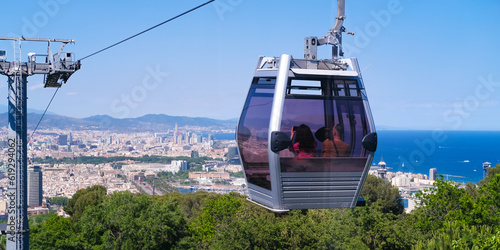 Tableau sur toile The funicular passes the support tower with a view from above of Barcelona and the sights