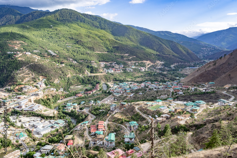 The city's vibrant blend of traditional architecture, lush greenery, and majestic mountains in Thimphu