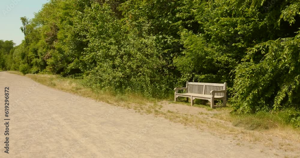 Lonely bench amidst greenery on a race track at the historic Hippodrome de Boitsfort track in Brussels. Lonely bench amidst greenery on a race track at the historic Hippodrome de Boitsfort track in Brussels.