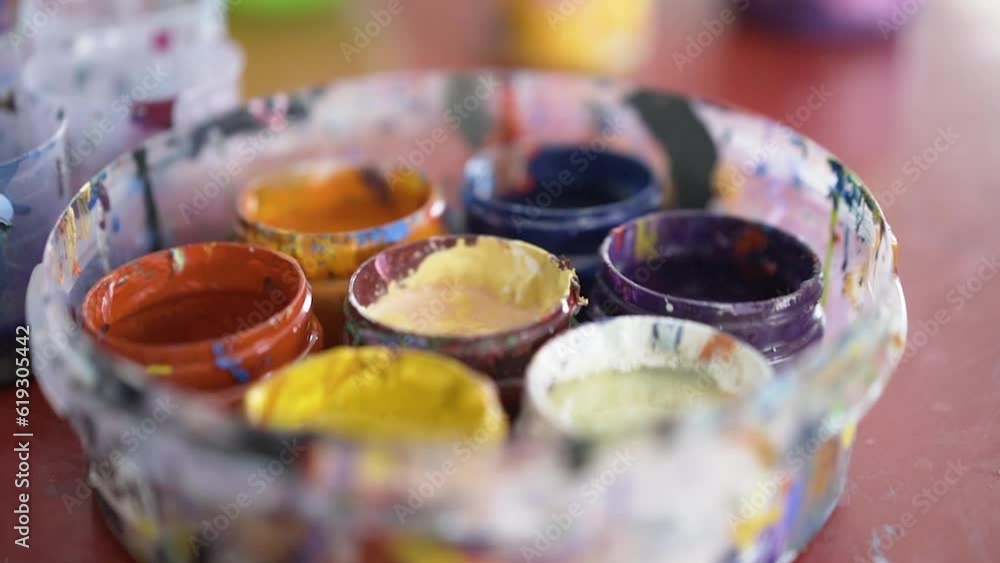Pot of brightly colored paints in an artist's studio, in Bahrain Pot of brightly colored paints in an artist's studio, in Bahrain