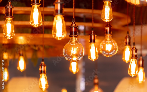 Decorative antique edison style filament light bulbs hanging from ceiling © schankz