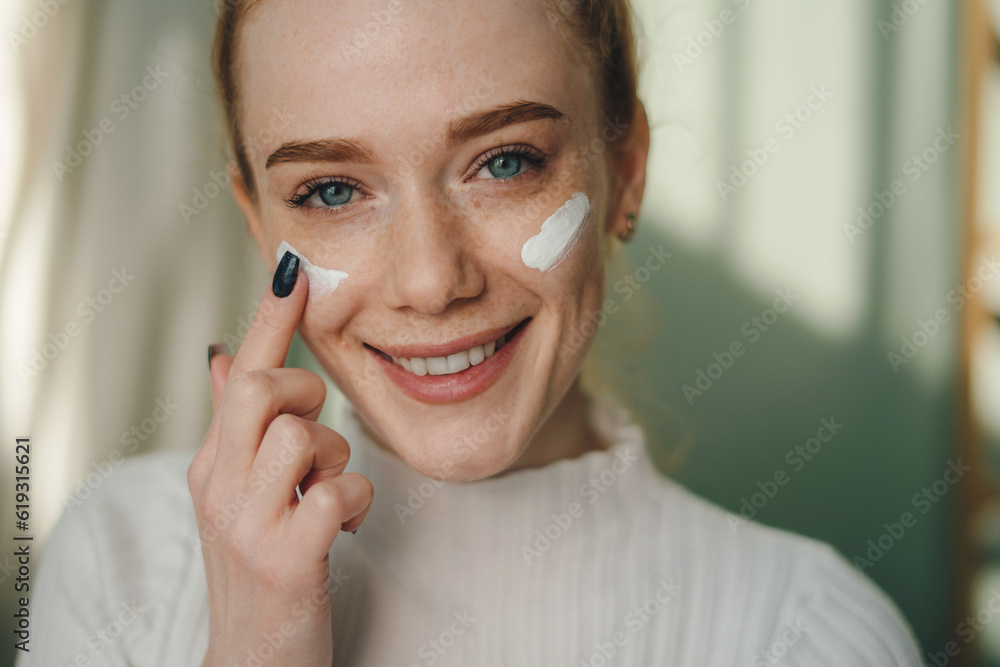 Positive young female with eye patches smiling and looking at camera while standing in light room Positive young female with eye patches smiling and looking at camera while standing in light room