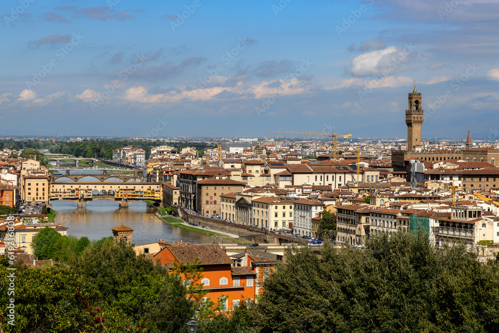 Obraz premium View over the Arno river and the Palazzo Vecchio in Florence, Tuscany, Italy, on a sunny day in spring.