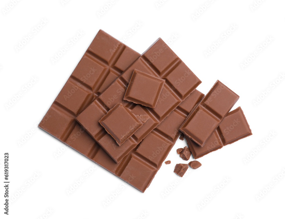 Fototapeta premium Pieces of delicious milk chocolate bars on white background, top view