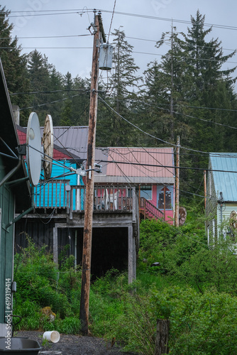 Street city view with wooden houses, shops, cars and mountain wilderness nature in Hoonah, Icy Strait Point in Alaska, popular cruise destination for whale watching in wildlife tours