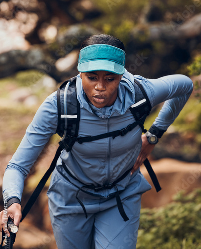 Hiking, fitness and tired black woman in nature walking for exercise, workout and adventure in woods. Sports, exhausted and female person trekking in forest for healthy body, wellness and freedom