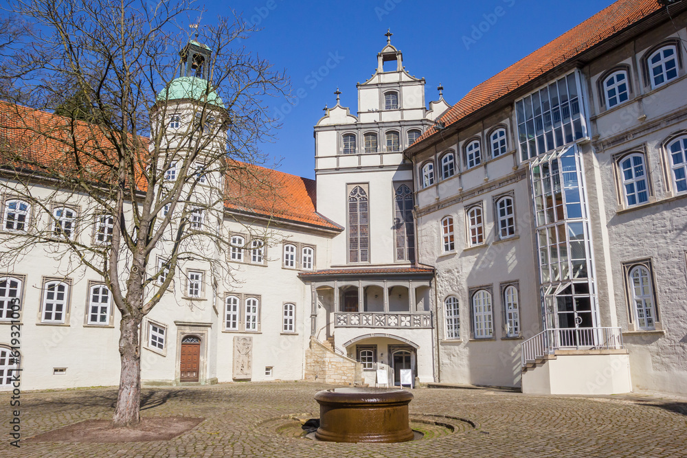 Well and tree on the courtyard of the castle in Gifhorn, Germany