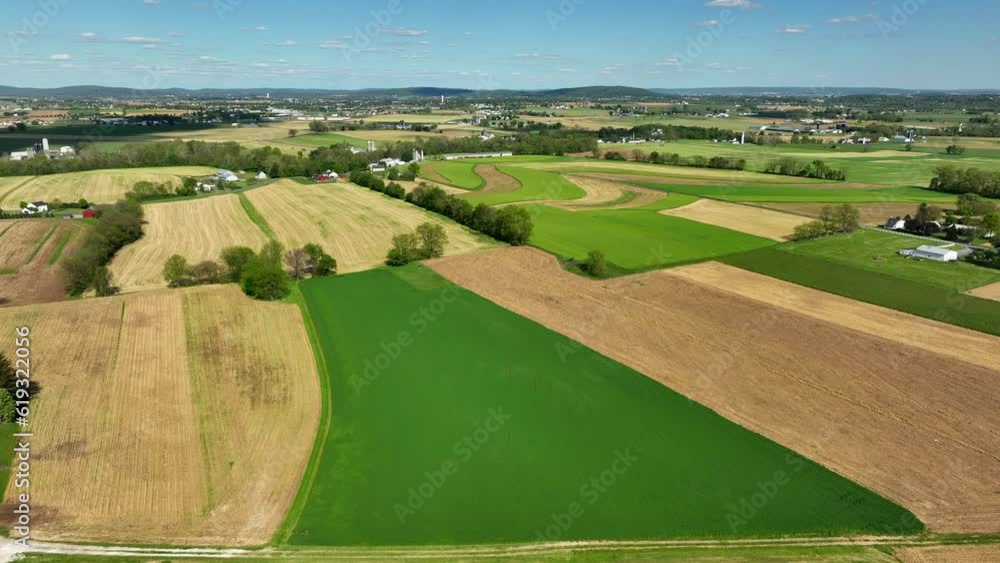 Aerial panorama view of agricultural farm fields in american during sunny day with hills at horizon Aerial panorama view of agricultural farm fields in american during sunny day with hills at horizon