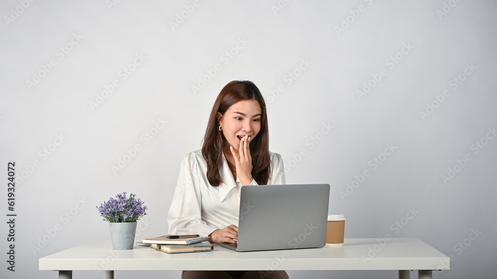 A shocked and surprised young Asian businesswoman stunned by the unexpected news. A shocked and surprised young Asian businesswoman stunned by the unexpected news.